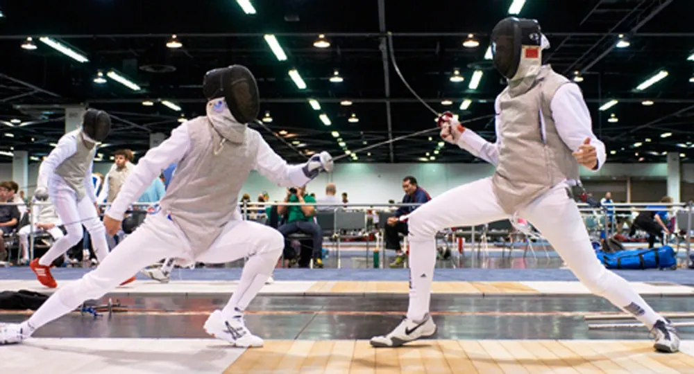 Two fencers competing in a bout