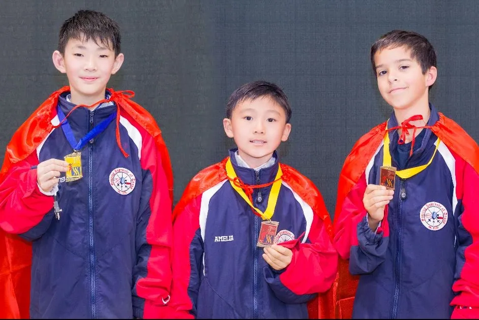 Young fencers wearing medals after competition