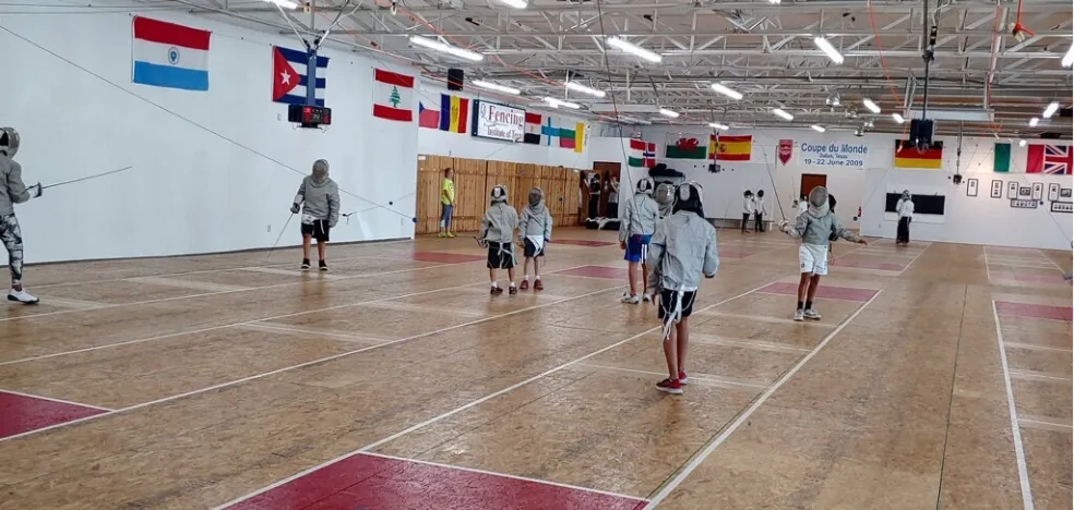 Fencers training across the institute floor
